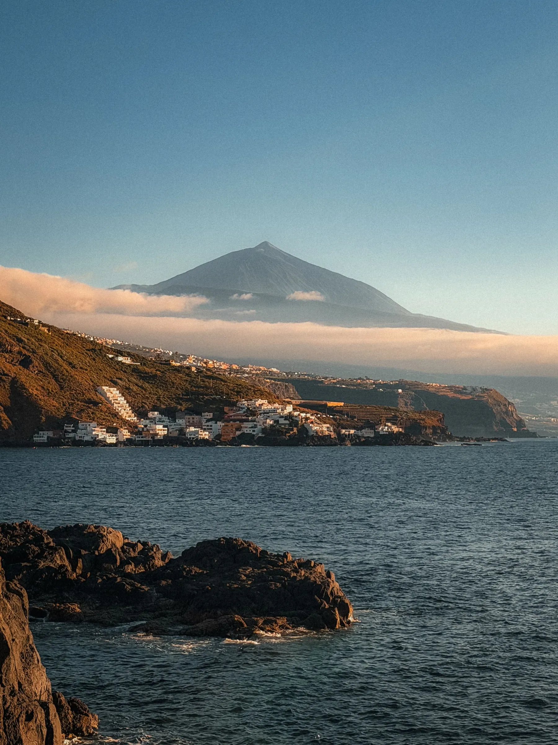Mount Teide rising above a band of cloud over the north coast of Tenerife